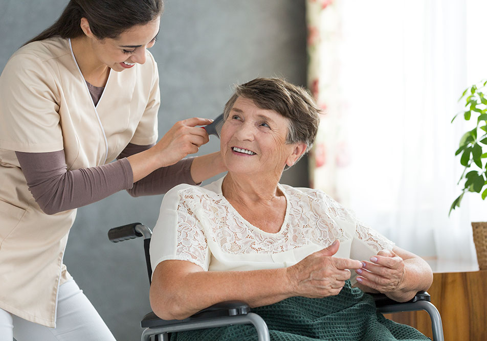 carer brushing elderly ladies hair